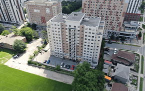 Waterloo apartment for rent - A large building with a parking lot in front of it.