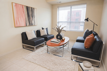 Waterloo apartment for rent - A living room with a black couch, a coffee table, and a painting on the wall.