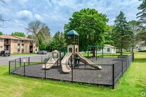 New York Mills apartment for rent - A playground with a slide and swings.