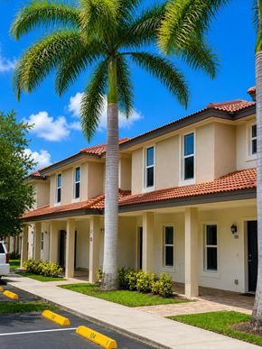 Bonita Springs apartment for rent - A row of houses with a palm tree in front.