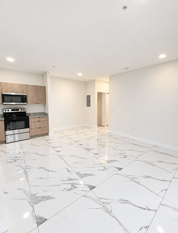 Hialeah apartment for rent - A kitchen with a marble floor and a microwave above the stove.