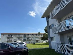 Cutler Bay apartment for rent - A row of cars parked in front of apartment buildings.