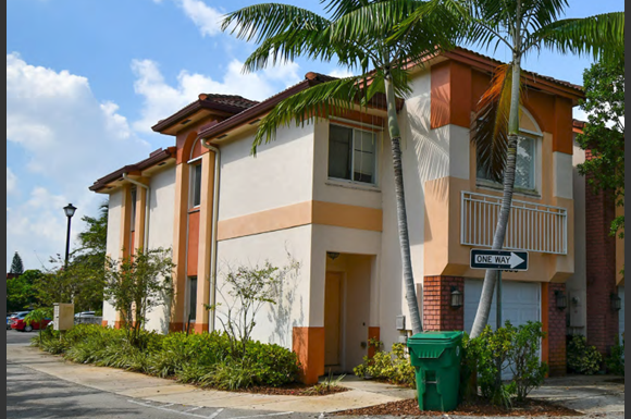 Davie apartment for rent - a row of houses with palm trees in front of them
