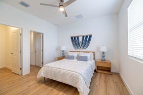 Ft Myers townhouse for rent - A bedroom with a bed and a ceiling fan