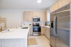 Ft Myers townhouse for rent - A kitchen with wooden cabinets and stainless steel appliances