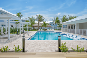 Ft Myers townhouse for rent - A swimming pool in front of a resort with white buildings