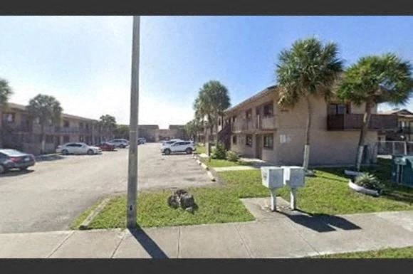 Hialeah apartment for rent - a street with cars parked in front of houses