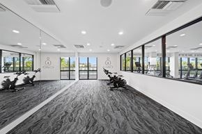 Miami apartment for rent - A gym with exercise machines and windows in a building