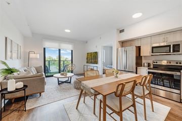 Miami apartment for rent - an open living room with a dining room table and a kitchen