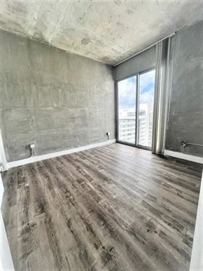 Miami apartment for rent - a living room with a wooden floor and a window