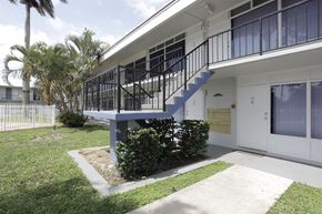 Oakland Park apartment for rent - the outside of a house with a staircase and a yard