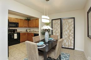 Oakland Park apartment for rent - A dining room with a table set for two and a vase of flowers.