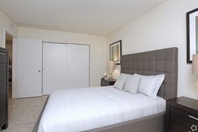 Oakland Park apartment for rent - A bedroom with a large bed and a dresser.