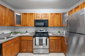 Oakland Park apartment for rent - A kitchen with wooden cabinets and stainless steel appliances.