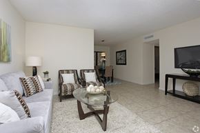 Oakland Park apartment for rent - A living room with a couch, chairs, and a coffee table.