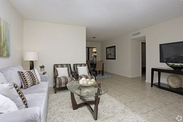 Oakland Park apartment for rent - A living room with a couch, chairs, and a coffee table.