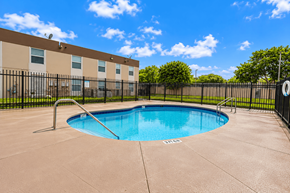 Miami apartment for rent - A small pool in a concrete patio surrounded by a black fence.