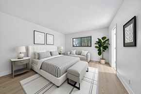 Lighthouse Point apartment for rent - A bedroom with a large bed and a couch.