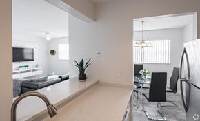 Boca Raton apartment for rent - A kitchen with a sink and a dining table.