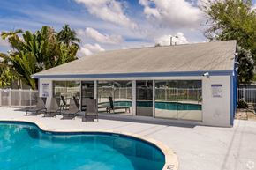 Riviera Beach apartment for rent - A pool with a building next to it.