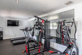 Riviera Beach apartment for rent - A gym with a row of treadmills and exercise bikes.