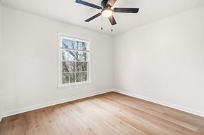 Verona apartment for rent - A room with a ceiling fan and a window with a view of trees.