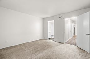 Staunton apartment for rent - A spacious, empty room with white walls and carpeted floor.