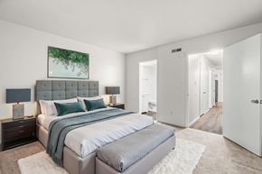 Staunton apartment for rent - A bedroom with a large bed and a painting on the wall.