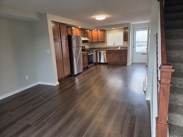 Manlius apartment for rent - A kitchen with wooden cabinets and a refrigerator.