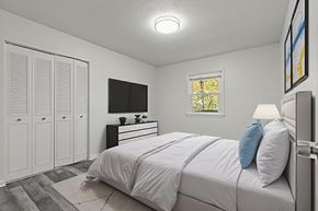 Staunton apartment for rent - A bedroom with a bed, dresser, and wardrobe.