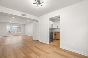 Verona apartment for rent - A spacious room with wooden floors and a ceiling fan.