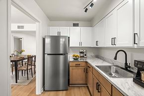 Verona apartment for rent - A modern kitchen with a stainless steel refrigerator and wooden cabinets.