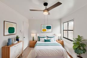Albany apartment for rent - A bedroom with a bed, nightstands, and a ceiling fan.