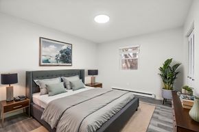 Staunton apartment for rent - A bedroom with a large bed and a painting on the wall.