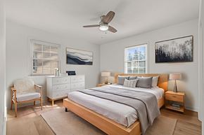 Waynesboro apartment for rent - A bedroom with a bed, nightstand, chair, and two pictures on the wall.