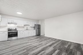 Staunton apartment for rent - A kitchen with white cabinets and a wooden floor.