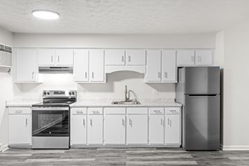 Staunton apartment for rent - A modern kitchen with white cabinets and appliances.