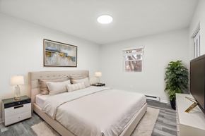 Staunton apartment for rent - A bedroom with a large bed and a painting on the wall.