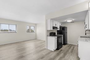 Fort Myers apartment for rent - A kitchen with white appliances and cabinets.