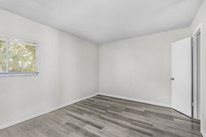 Fort Myers apartment for rent - A room with a wooden floor and a window.