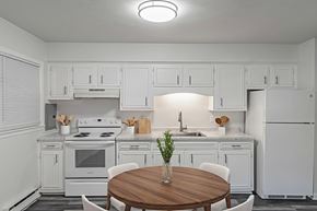 Staunton apartment for rent - A white kitchen with a wooden table and chairs.