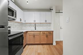 Albany apartment for rent - A kitchen with wooden cabinets and a black oven.
