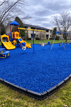 Cicero apartment for rent - A playground with a blue rubberized surface and yellow slides.