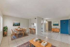 Fort Myers apartment for rent - A dining room with a table set for four and a blue door.