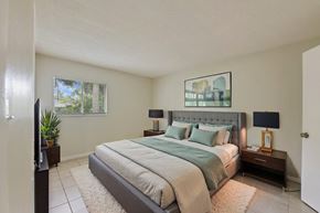 Fort Myers apartment for rent - A bedroom with a large bed and a flat screen TV.