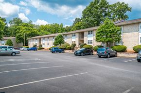 Staunton apartment for rent - A parking lot with cars and apartment buildings in the background.