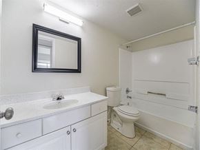 Fort Myers apartment for rent - a bathroom with a toilet and a sink and a mirror