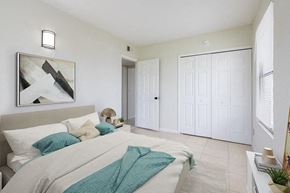 Merritt Island apartment for rent - a bedroom with a large bed and a painting on the wall
