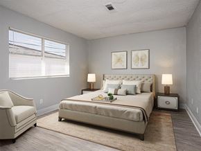 Milton apartment for rent - a bedroom with a bed and a chair and a window