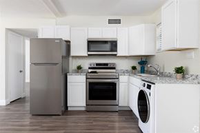 Titusville apartment for rent - a kitchen with white cabinets and stainless steel appliances
